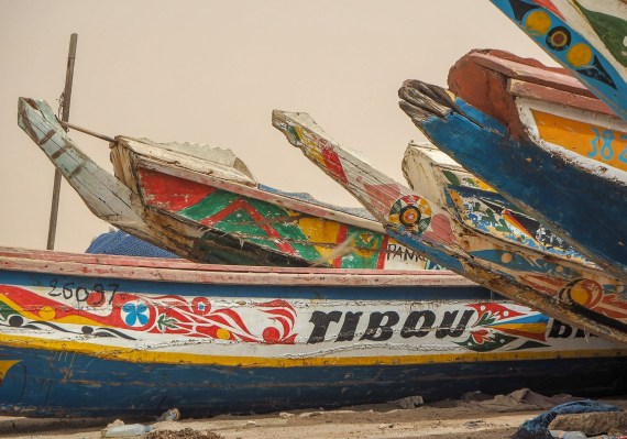 Colorful fishing boats lined up at the bustling fish market in Nouakchott.