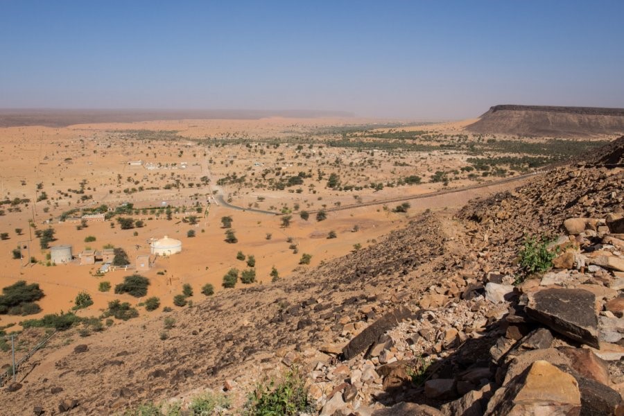 Historic ruins of Azougui, Mauritania, showcasing ancient stone structures against a desert backdrop. A highlight of Adrar Desert Adventure Tours.