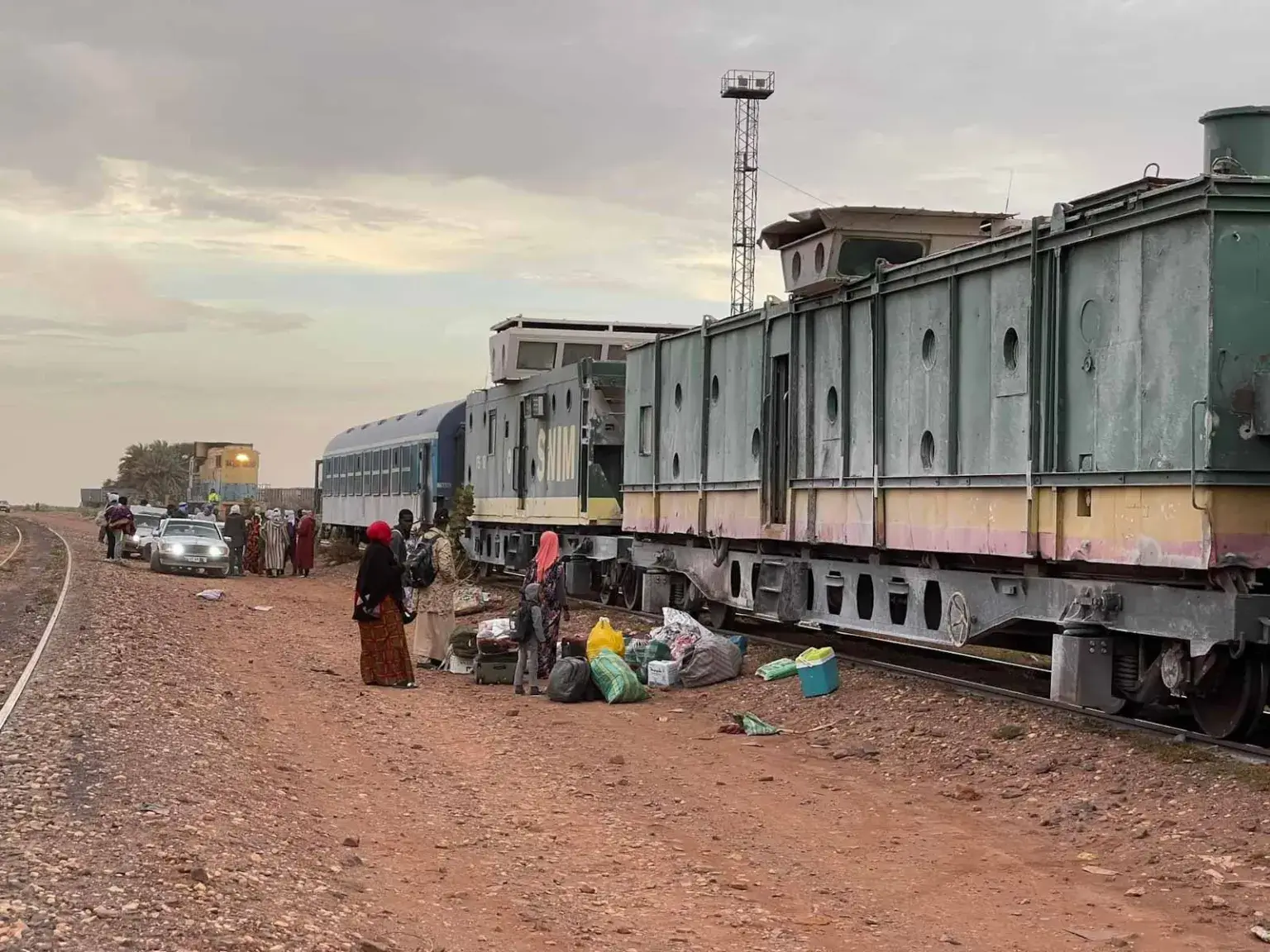 Iron ore train crossing the Mauritanian desert, carrying heavy cargo through the Sahara.
