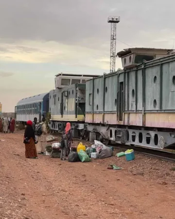 Iron ore train crossing the Mauritanian desert, carrying heavy cargo through the Sahara.