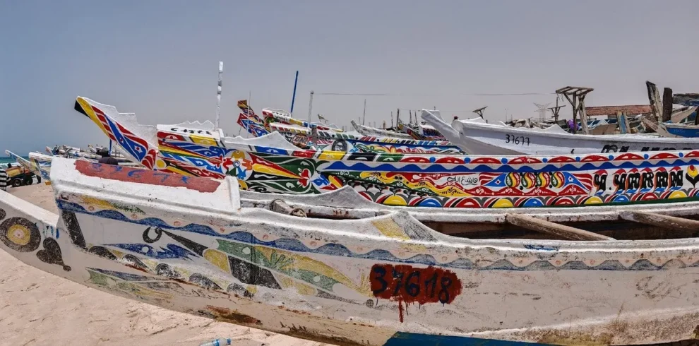 Colorful painted pirogues on the beach at the Nouakchott Fish Market, Mauritania
